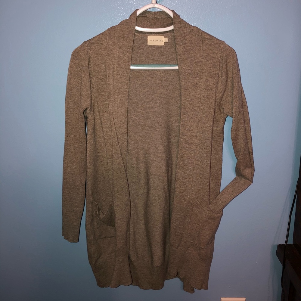 Light brown/tan cardigan. Covers the butt.